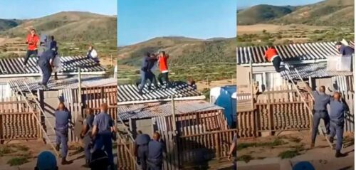 Boy Throw Punches With Police Officers On The Roof Of A House - Video